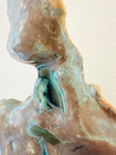 Ecco. Serie "Emergence". Scultura femminile in ceramica dai toni grigio-smeraldo.