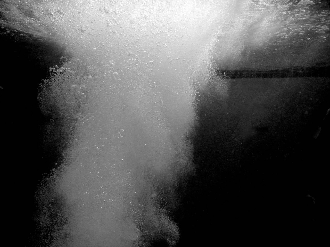 Eric Zener Black and White Photograph - WATER STUDY 1,  huge splash in water, bubbles, black and white, dark water