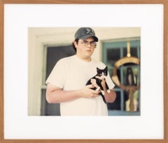 Untitled (Man Holding a Black and White Kitten), Chromogenic Print