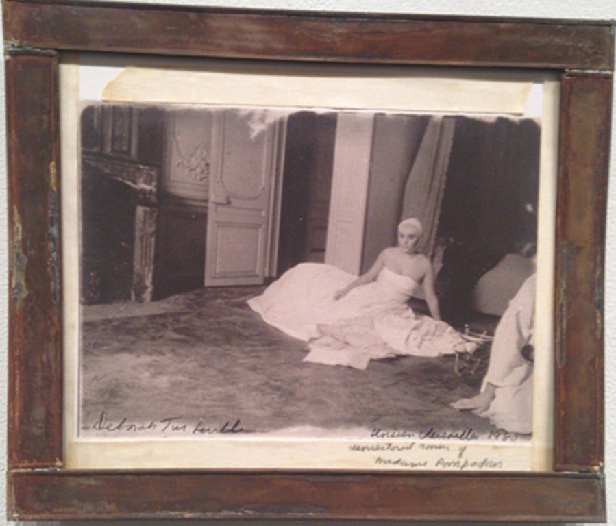 Deborah Turbeville Black and White Photograph - Woman seating in the unrestored bedroom of Madame Pompadour