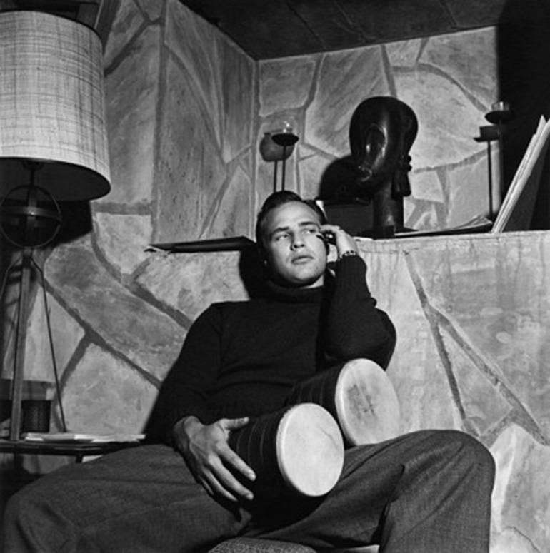 Sid Avery Black and White Photograph - Marlon Brando with bongo drums at his Beverly Hills home