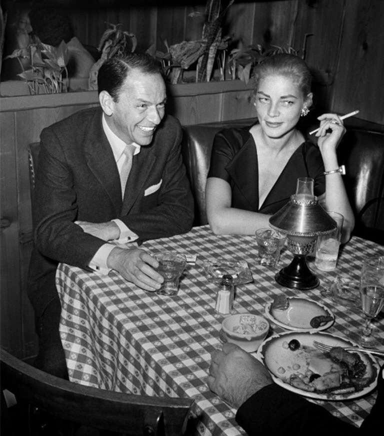 Frank Worth Black and White Photograph - Frank Sinatra and Lauren Bacall at Musso & Frank Grill, 1957