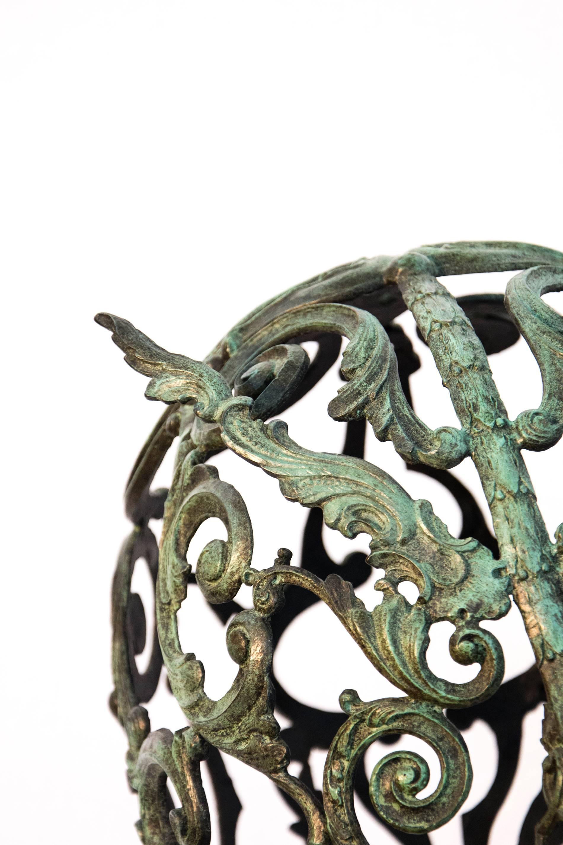 Bronze head fashion from cast found objects - the decorative elements added to furniture early in the last century. This piece is cast using elements of wood molding to create a mask in patina bronze. This body of work references the Baroque and