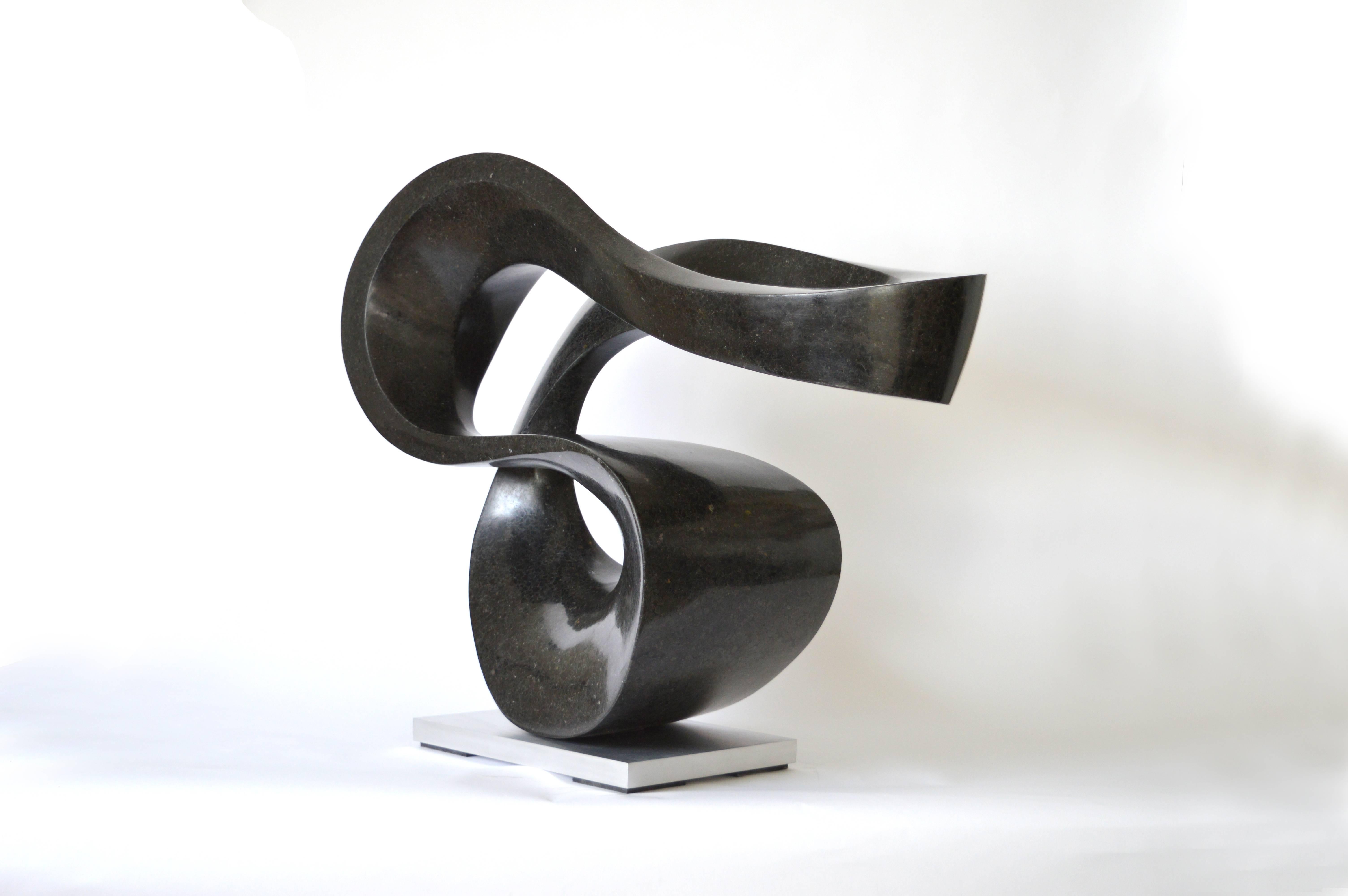 Smooth surfaced, black granite flecked almost imperceptibly with copper and white has been engineered into an elegant ribbon in tangible contrast to its weight.  This work has a steel substructure and sits on an aluminum base. The work is aptly