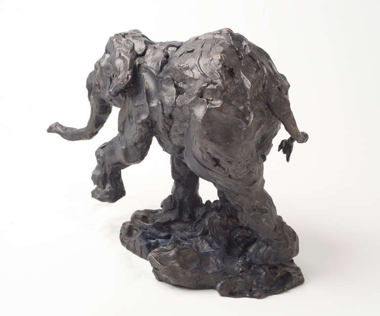 This charming bronze statuette of a walking elephant is rendered in a lively texture with an elegant sepia patina. Alberta-based sculptor Richard Tosczak begins his pieces with rapid pen and ink studies that evolve into dynamic three dimensional