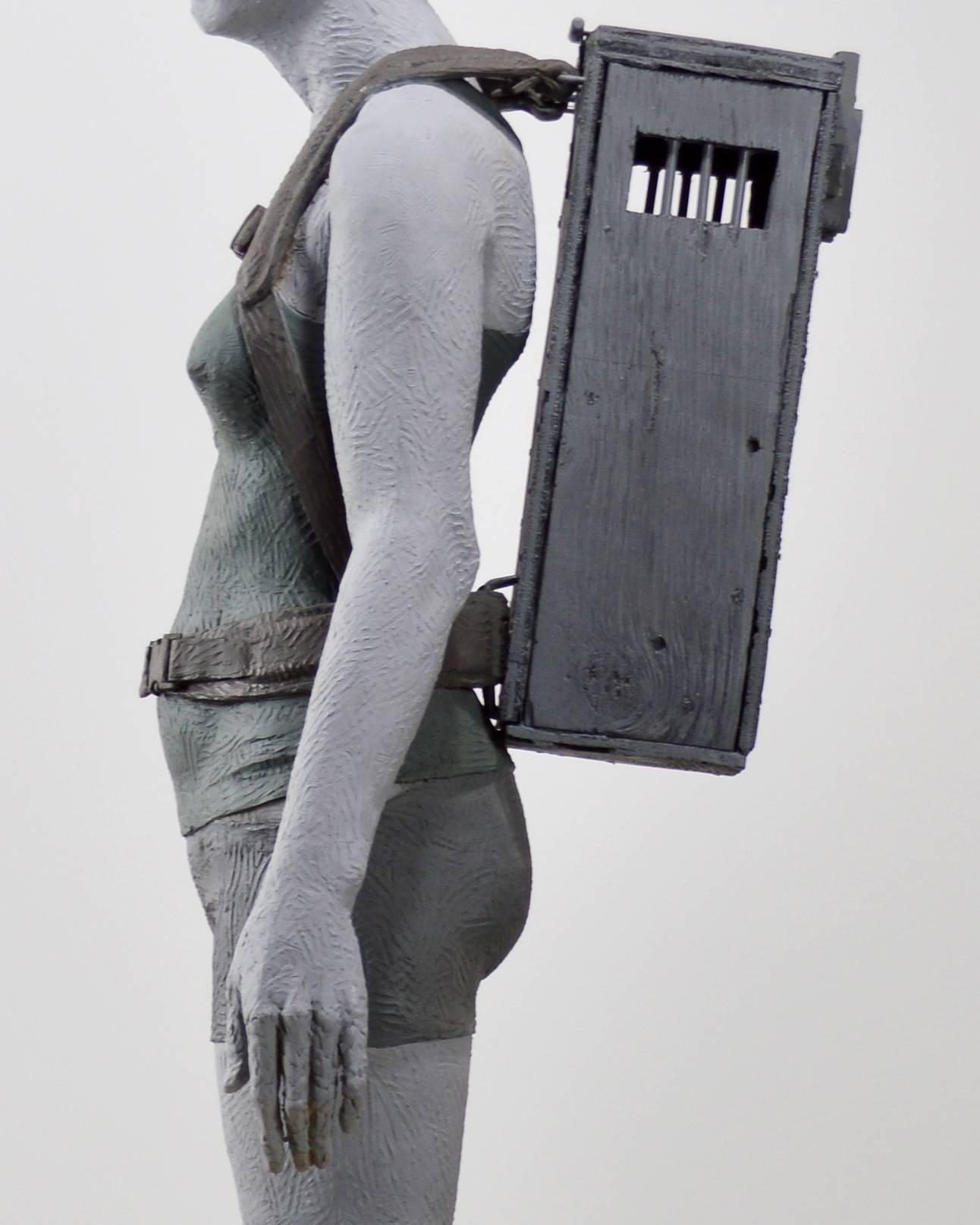 Girl With Crate 1 of 3 - tall, figurative, female, muted colour, resin sculpture - Gray Figurative Sculpture by Nicholas Crombach