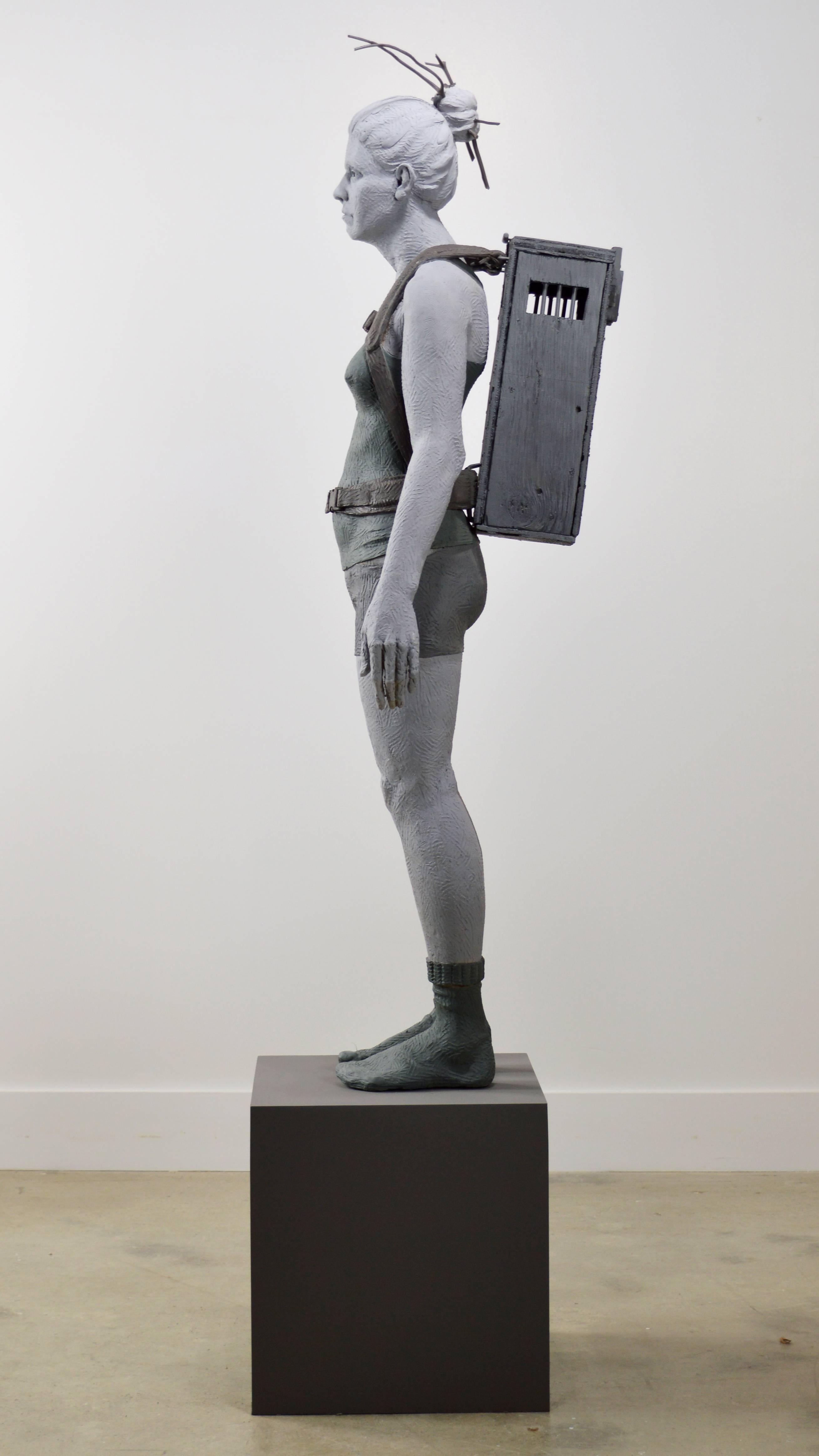 Girl With Crate 1 of 3 - tall, figurative, female, muted colour, resin sculpture - Sculpture by Nicholas Crombach