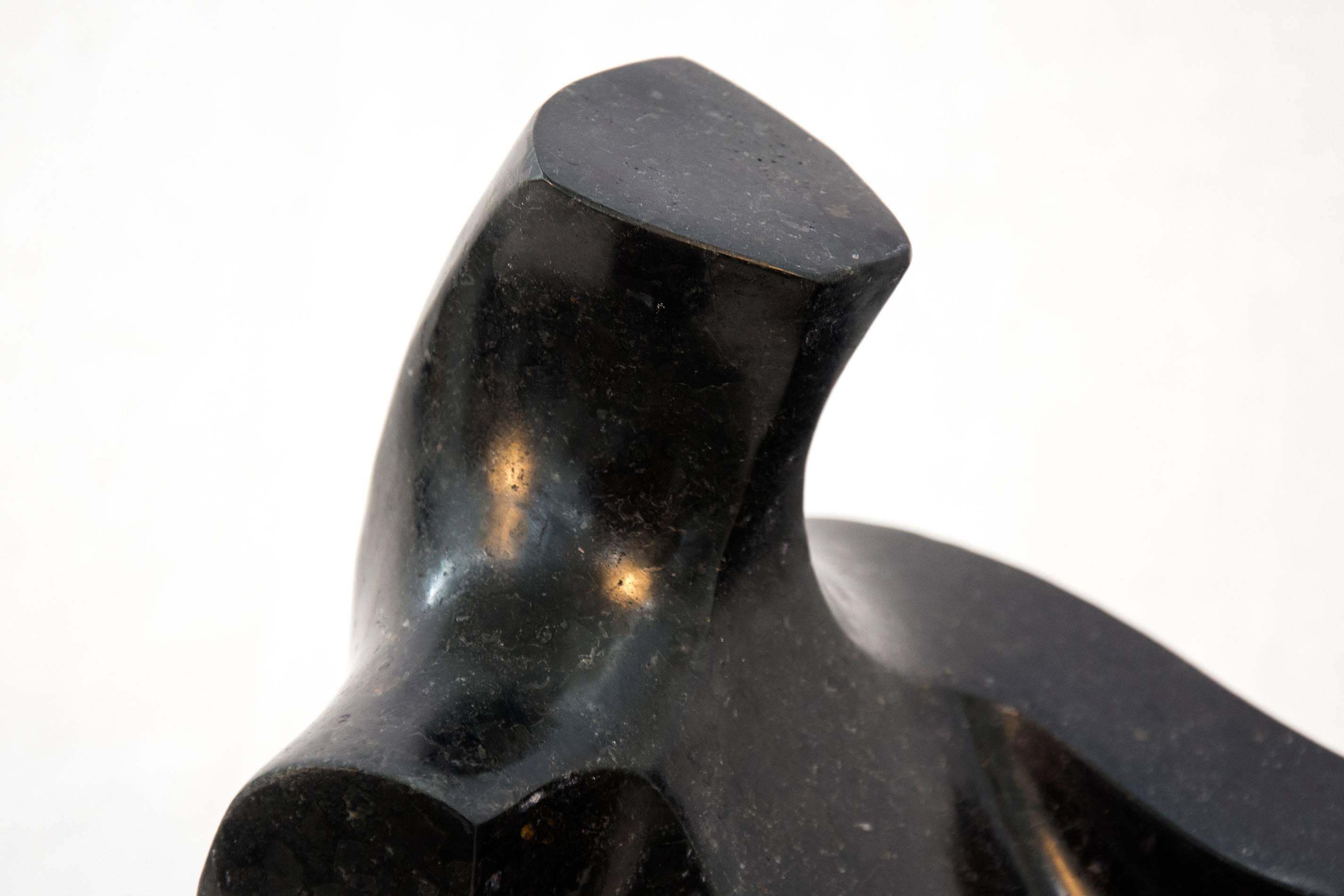 Smooth surfaced, black granite has been engineered into an elegant, modern depiction of a reclining figure. The play of space and shape changes as the viewer and light move around this classic figurative subject. This work is number 8 in a series of