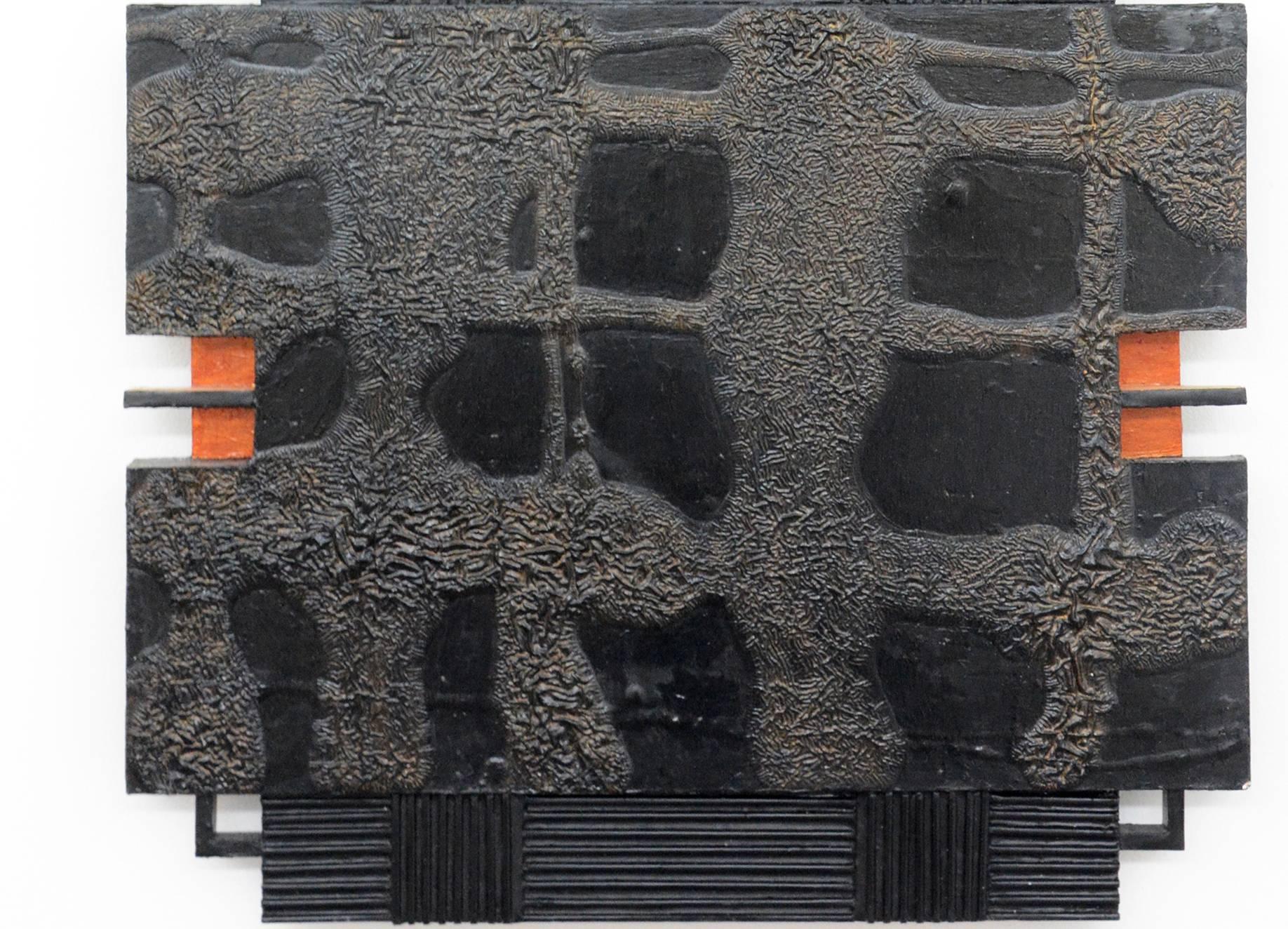 Two textured, brown and black patinated, wood sections each with two orange cutouts intersect with a ribbed black vertical in this 30 inches tall wall relief.  

