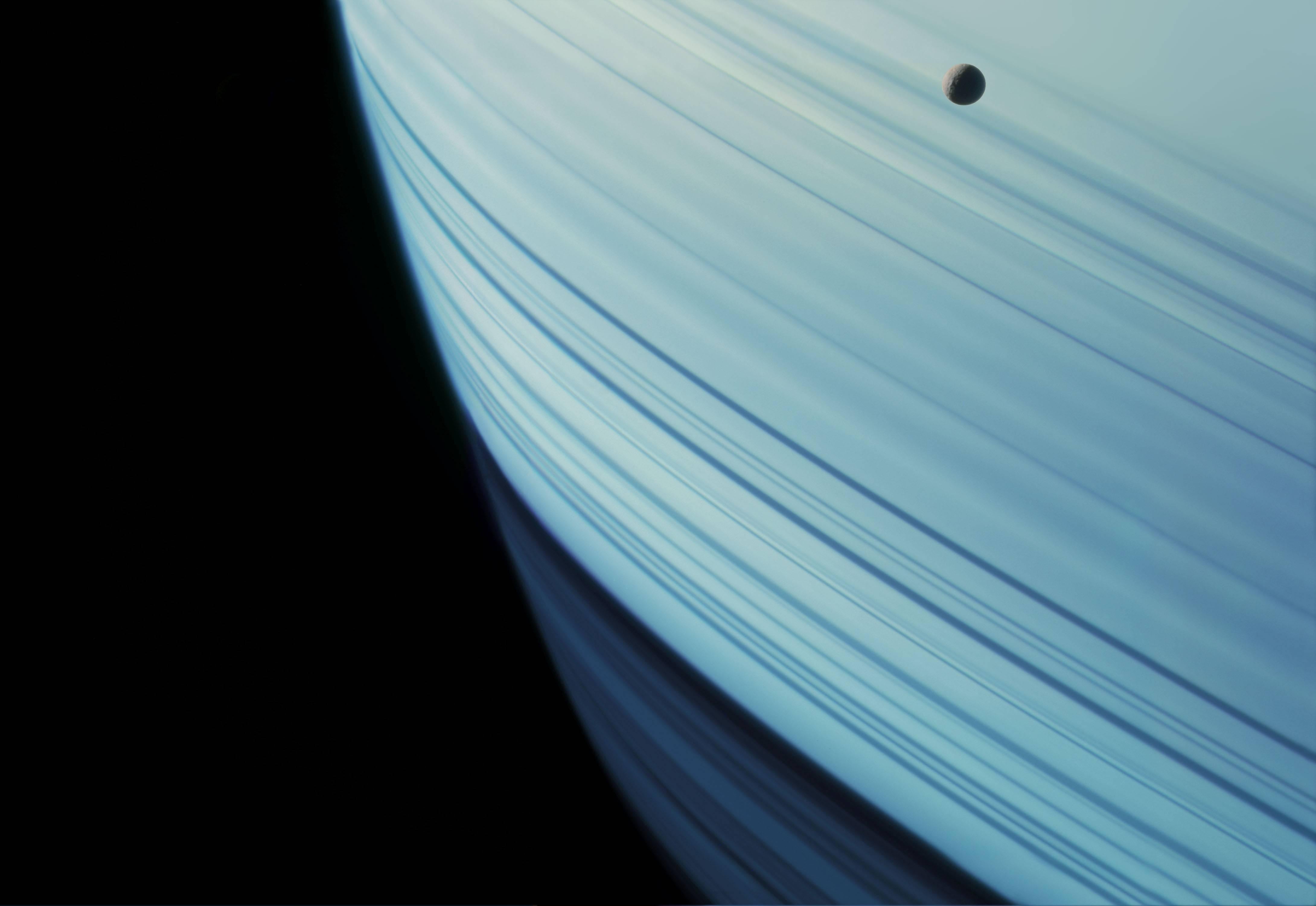 Michael Benson Color Photograph - Mimas Transits Saturn’s Ring Shadows, Cassini, January 18, 2005