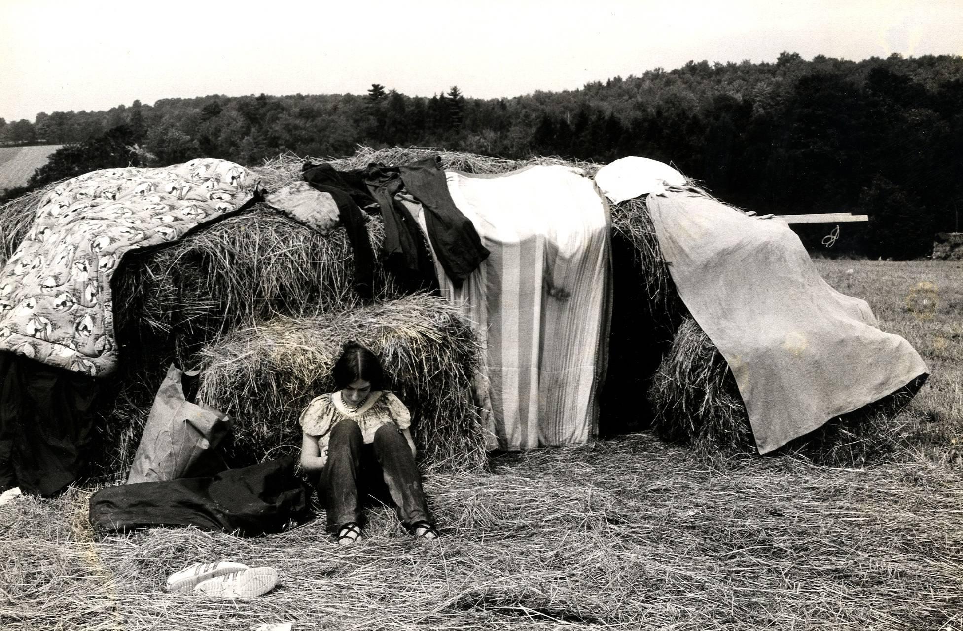Burk Uzzle Black and White Photograph - Woodstock (girl with hay bales)