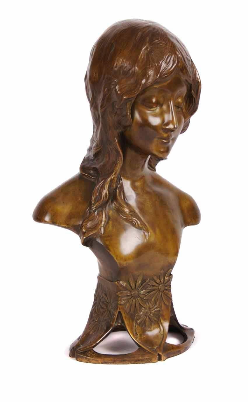A beautifully executed French Art Nouveau period bronze bust by Paul-Lucien Bessin. A woman with daisies in her hair on an openwork base with daisy stems. Mold incised signature and L. Duchet foundry seal.