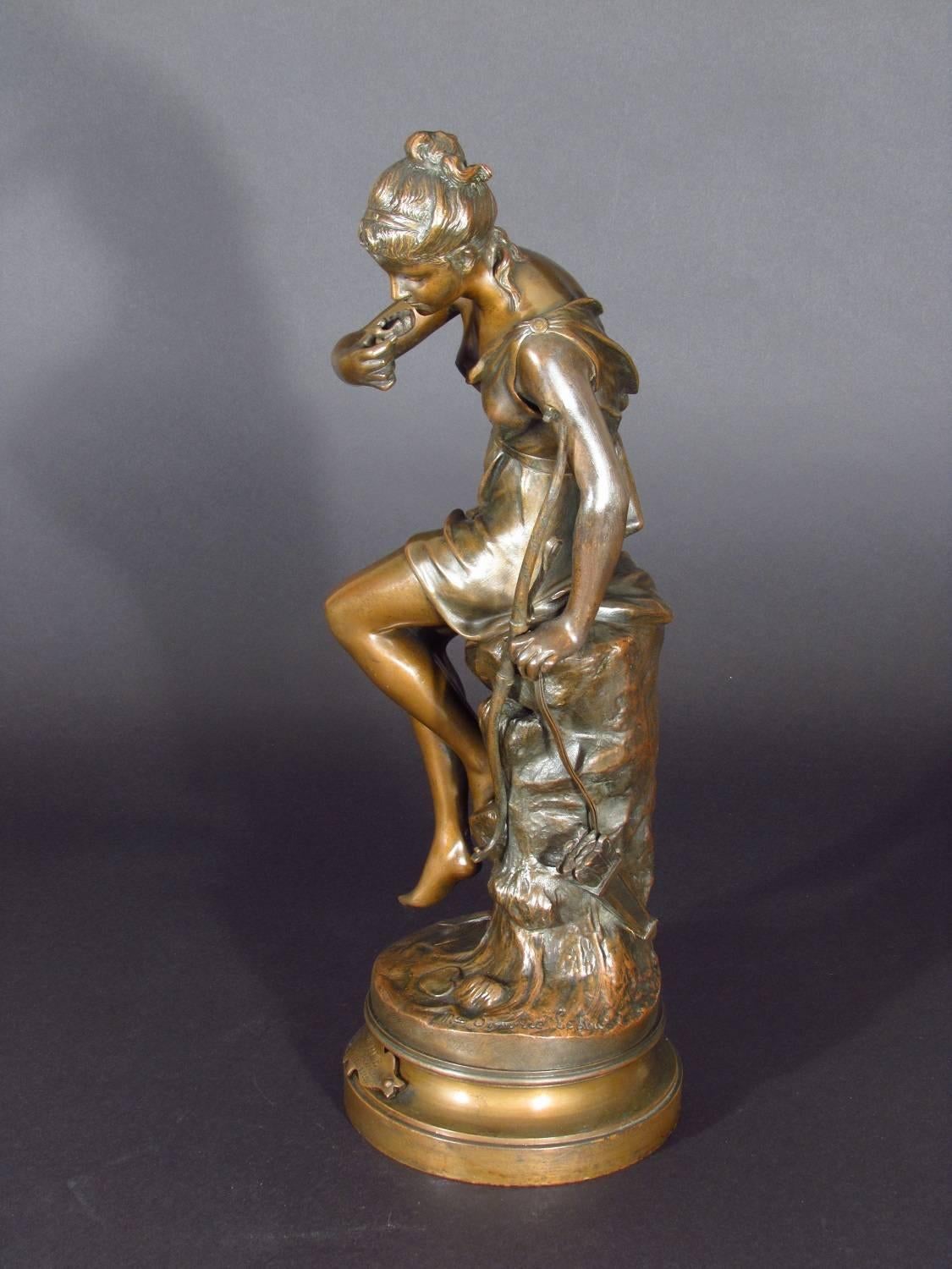 Antique bronze figure of a nymph of Diana drinking from  a spring - the source. 
 Diana was the Greek/Roman goddess of the moon, nature and the hunt.

Plaque to base inscribed: Source par Mme. Signoret-Ledieu  Recompensée au Salon

                 