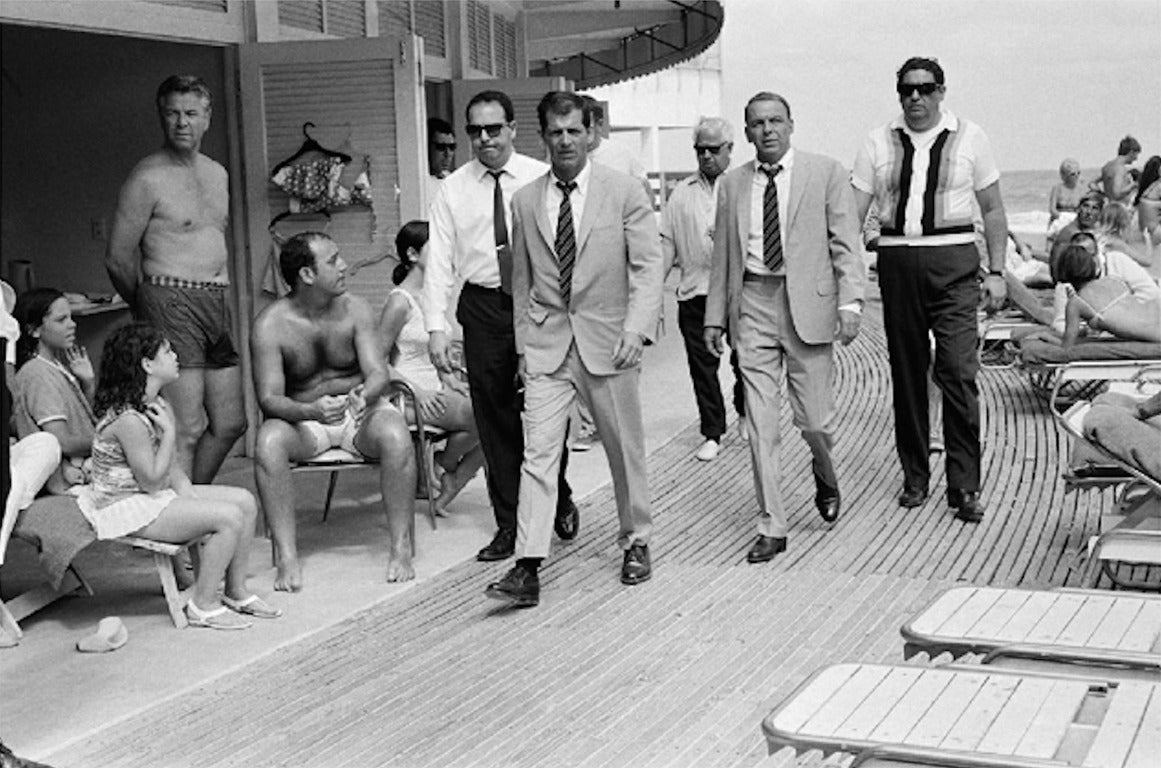 Terry O'Neill Black and White Photograph - Frank Sinatra and entourage on Miami Beach