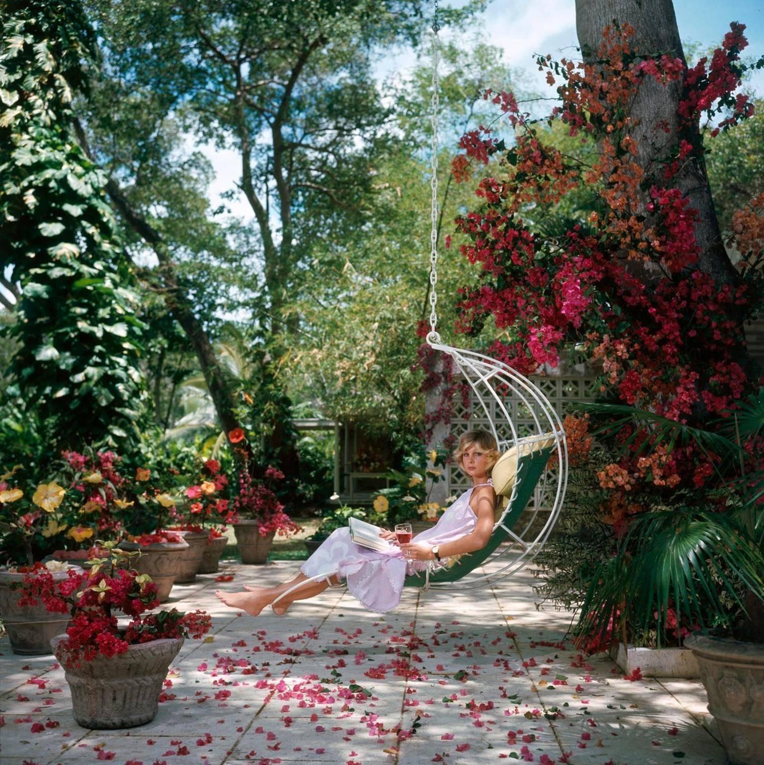 Ava Marshall relaxes with a book amongst the bougainvillea in Barbados, April 1976.

Estate stamped and hand numbered edition of 150 with certificate of authenticity from the estate.   

Slim Aarons (1916-2006) worked mainly for society