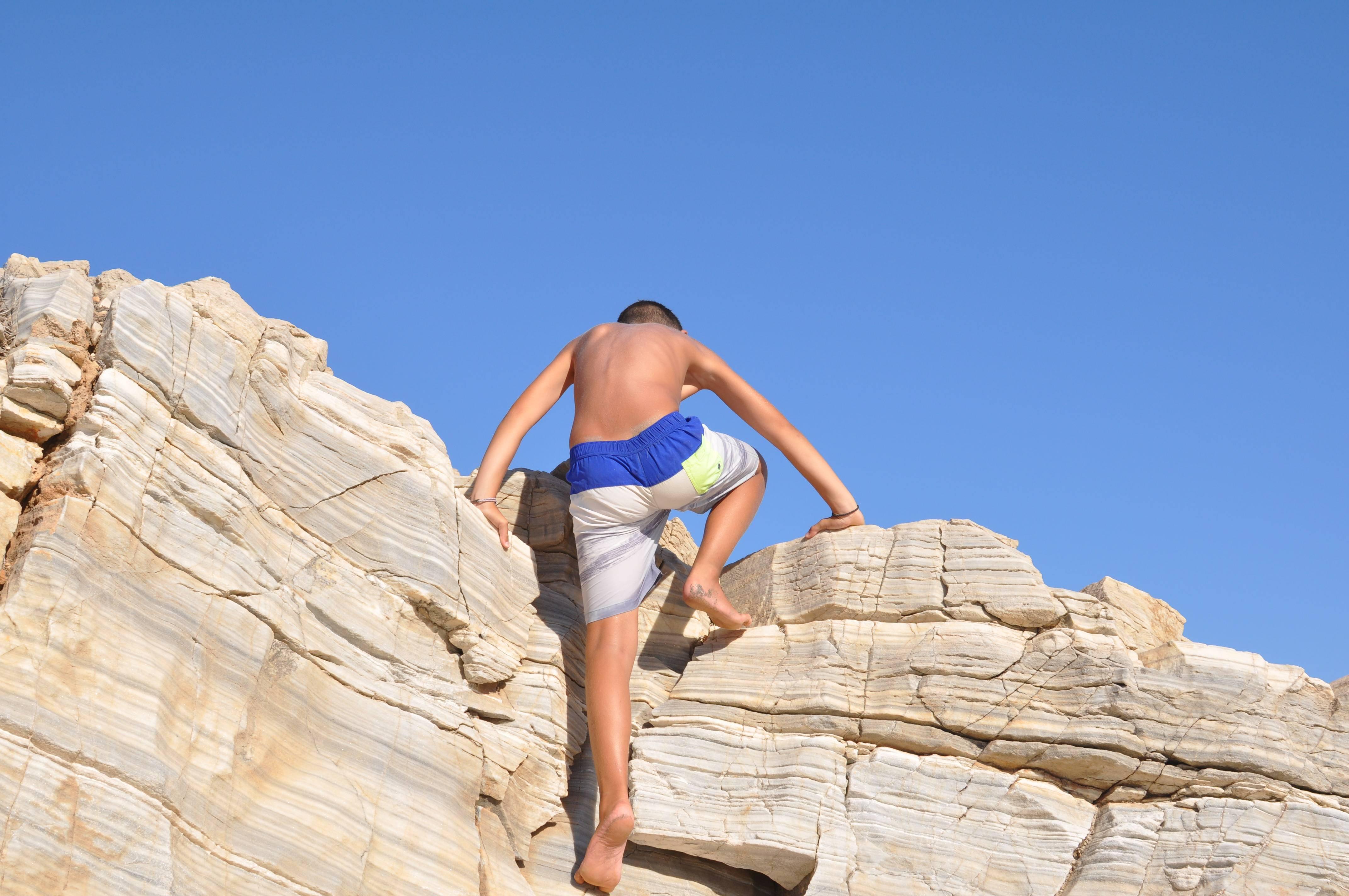 Leandros Pigades Figurative Photograph - Climbing Boy, Aegean Marble Sky