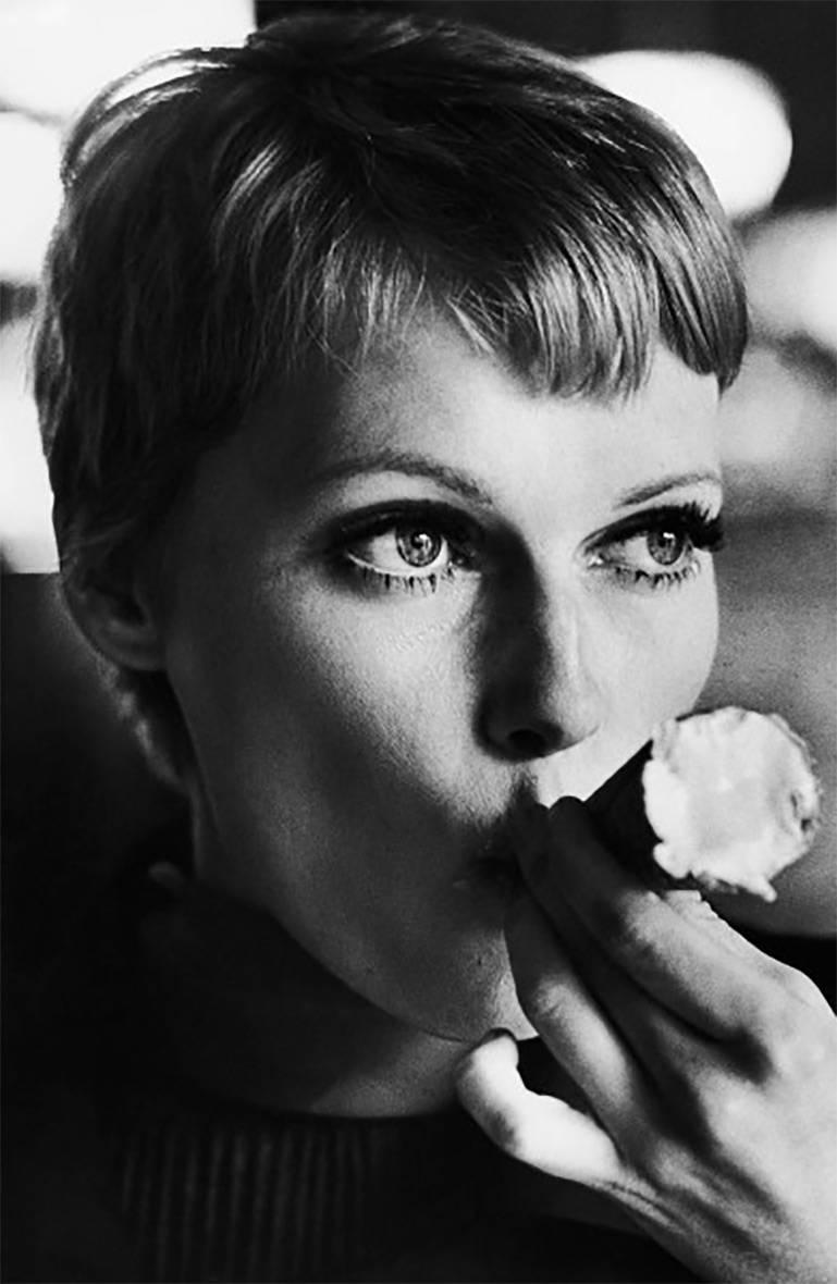 Terry O'Neill Black and White Photograph - Mia Farrow Eating Ice Cream