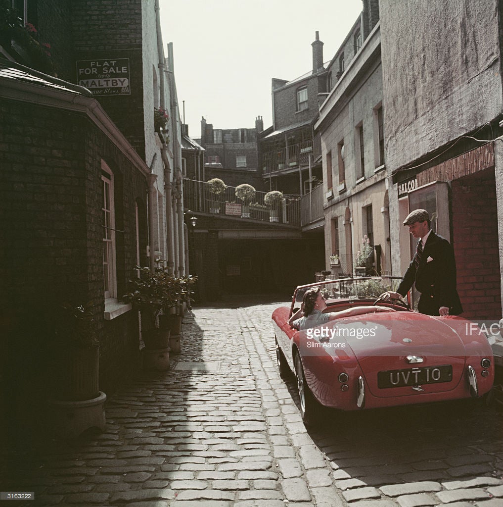 Slim Aarons Color Photograph - Sports Car Couple (Estate Edition)