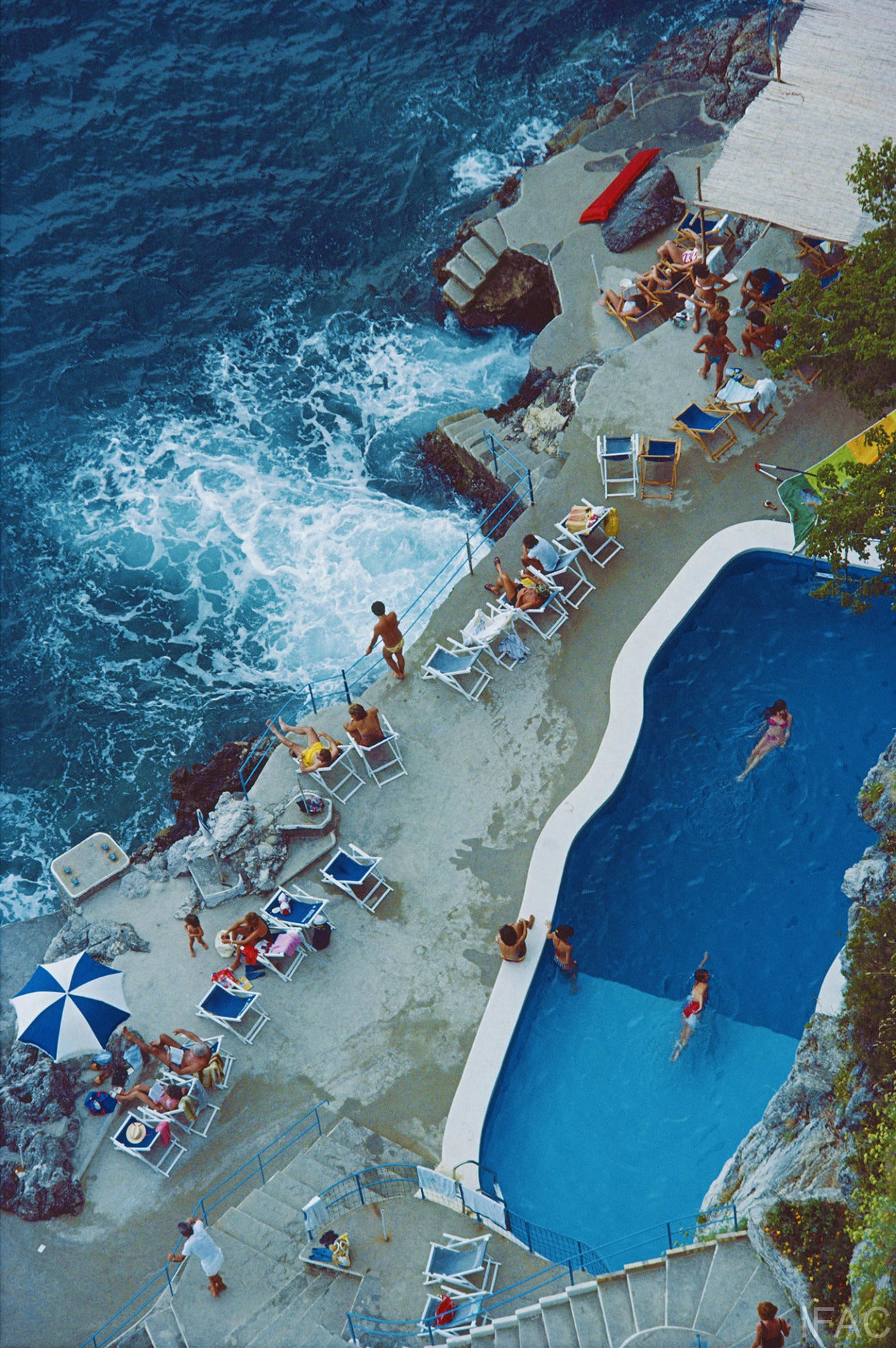 A view of the seaside pool at the Hotel St. Caterina, Amalfi, Italy, September 1984.

Estate stamped and hand numbered edition of 150 with certificate of authenticity from the Slim Aarons Estate. 

Slim Aarons (1916-2006) worked mainly for