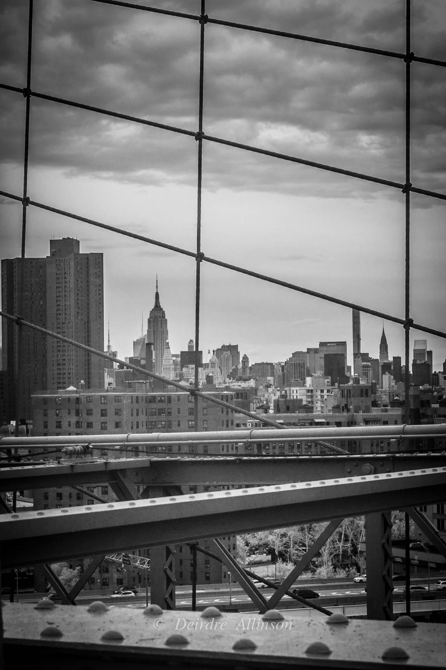 Deirdre Allinson Landscape Photograph - Framed. (New York Skyline Through Brooklyn Bridge Cables