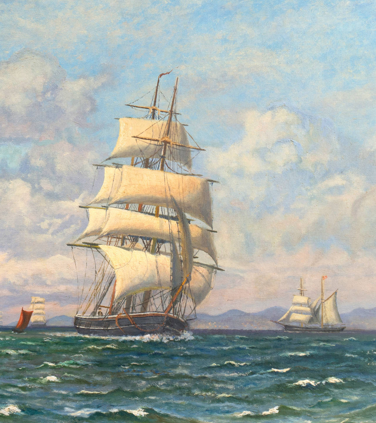 A fine and substantial early twentieth-century oil seascape showing a view of a three-masted sailing ship and other vessels in a stiff breeze on choppy waters beneath a scudding cloudy sky with a view towards Kronberg castle in the distance.