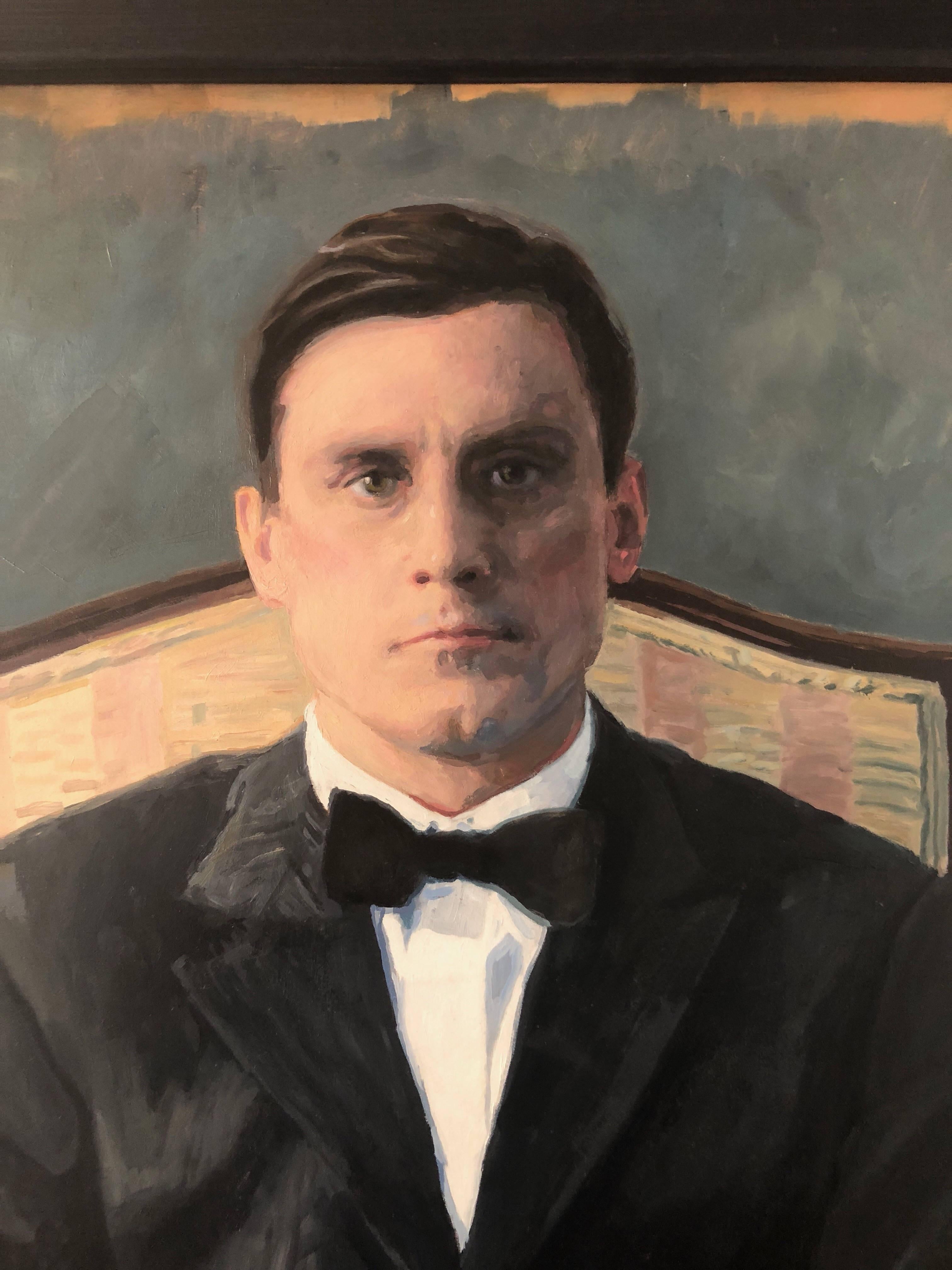 man sitting in chair painting