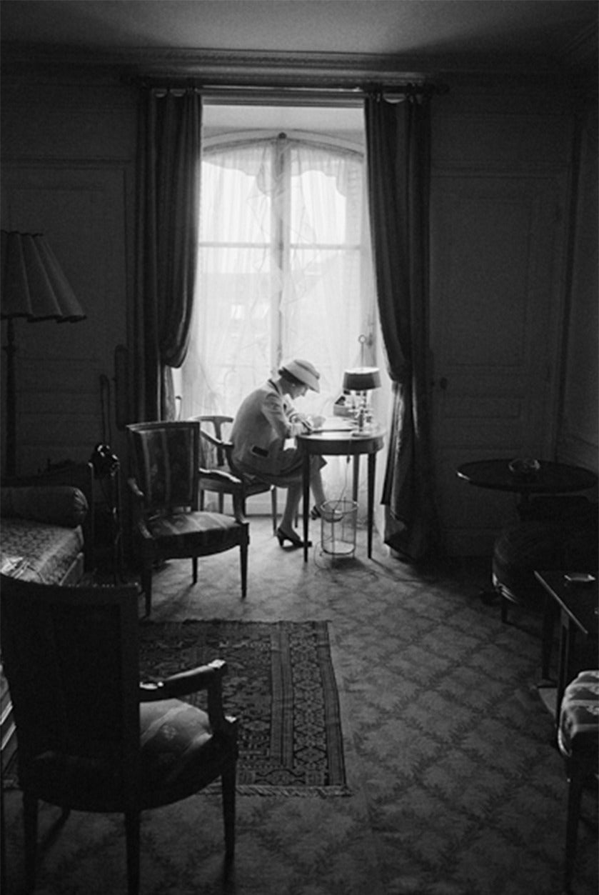 Mark Shaw Portrait Photograph - Coco Chanel Writes At Her Desk, Head Down