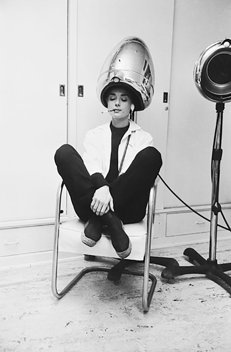 Mark Shaw Black and White Photograph - Audrey Hepburn Smoking Under a Hair Dryer, 1953