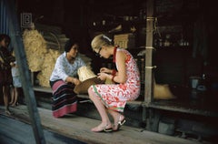 Tiger Morse Examines a Straw Hat, Bangkok, 1962