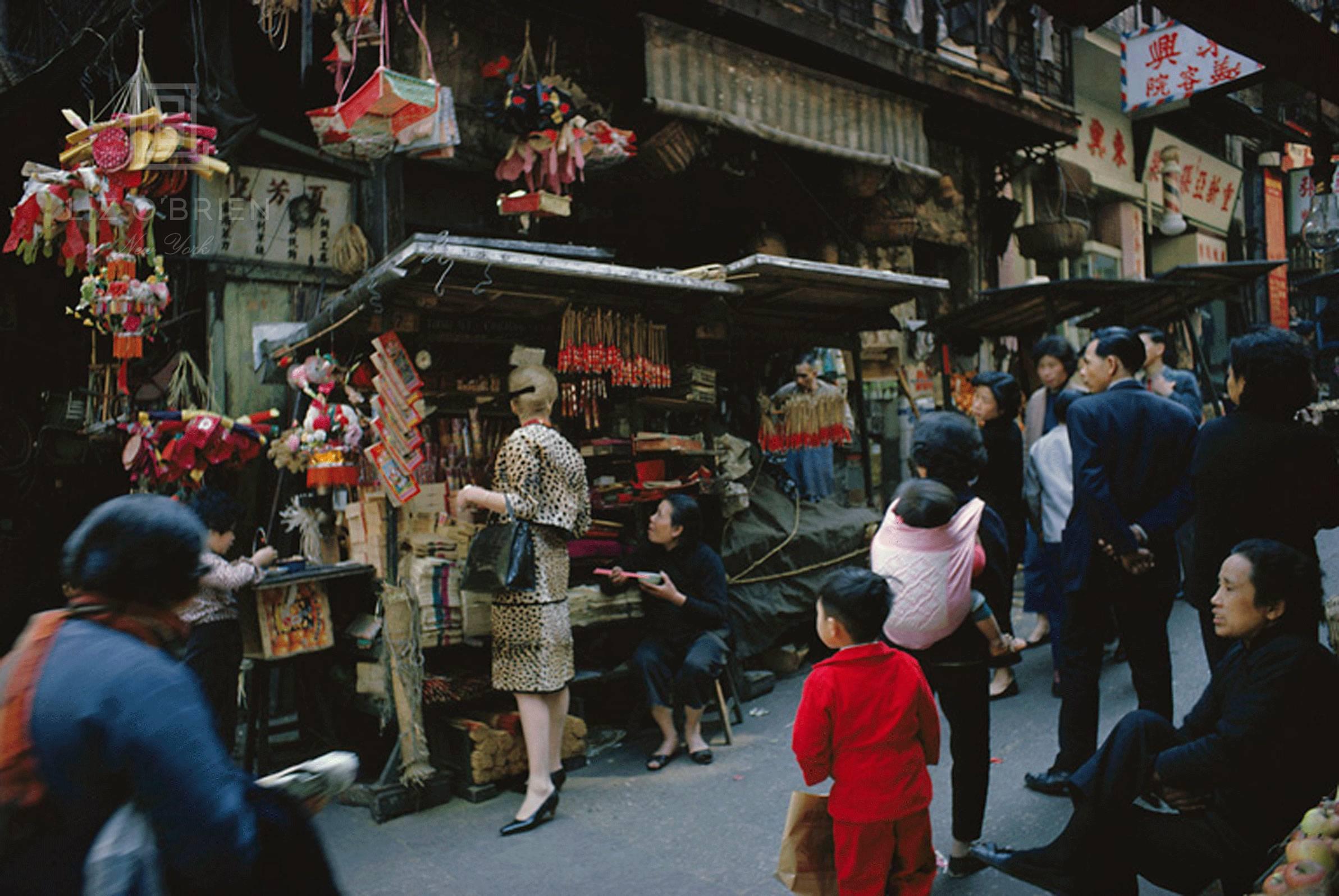 Mark Shaw Color Photograph - Tiger Morse Shops the Street Market #3, Hong Kong, 1962