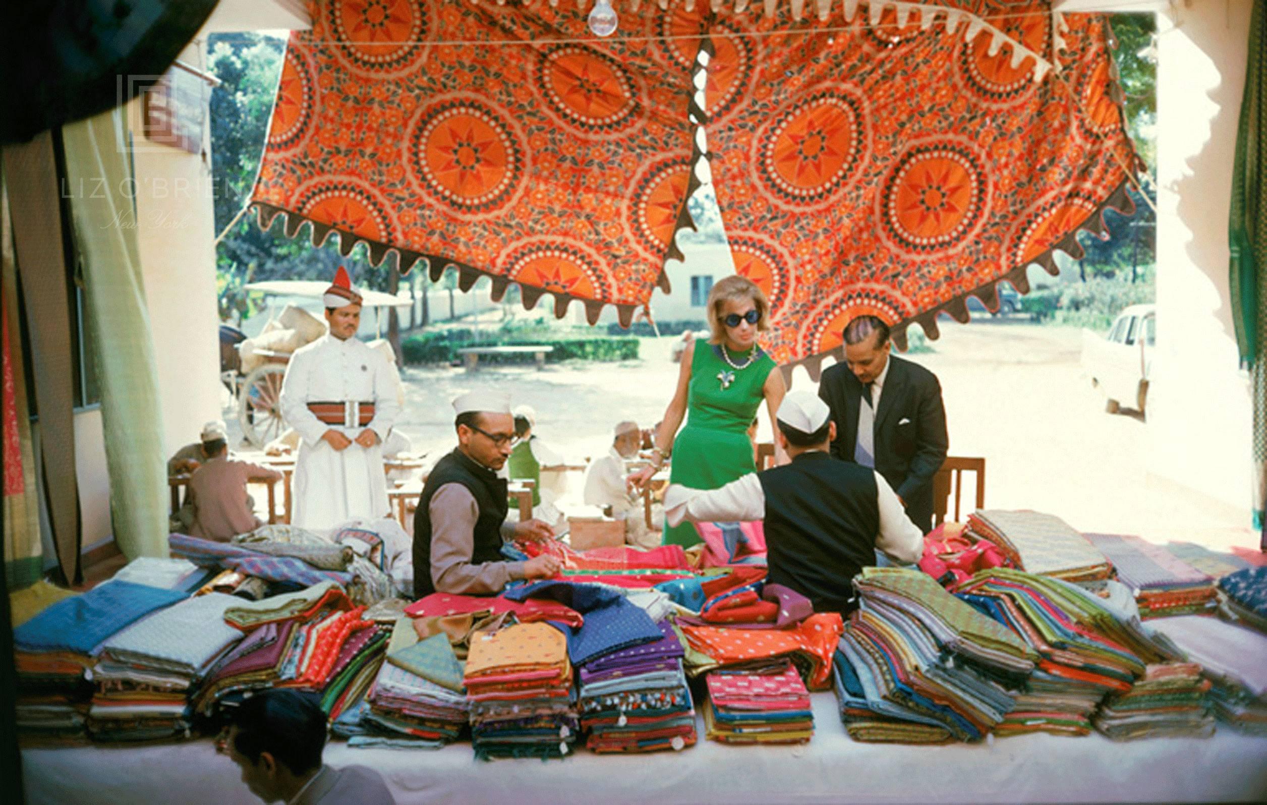 Mark Shaw Color Photograph - Tiger Morse Examines Saris, Benares, 1962