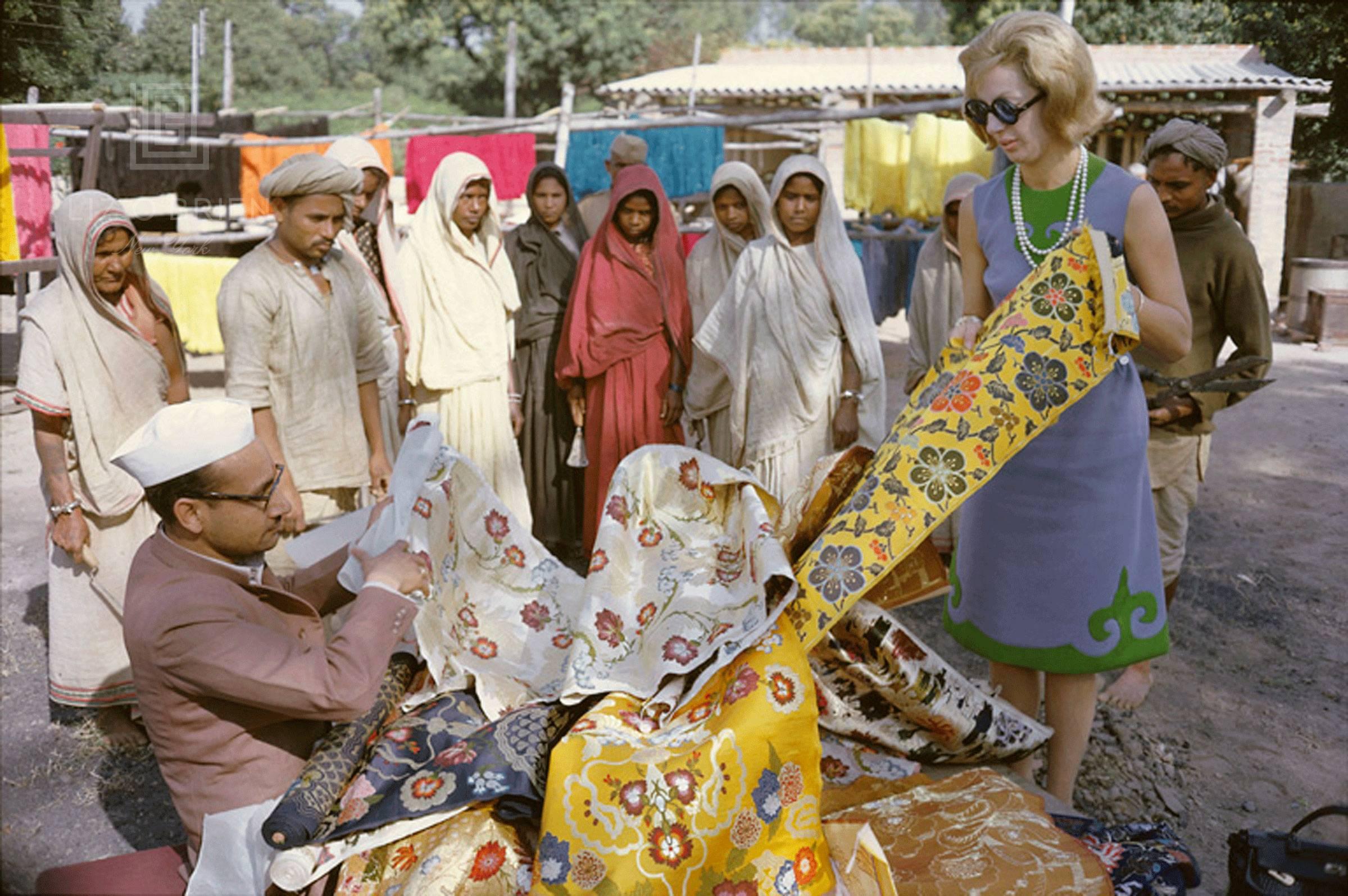 Mark Shaw Color Photograph - Tiger Morse Browses Brocades, Benares, 1962  