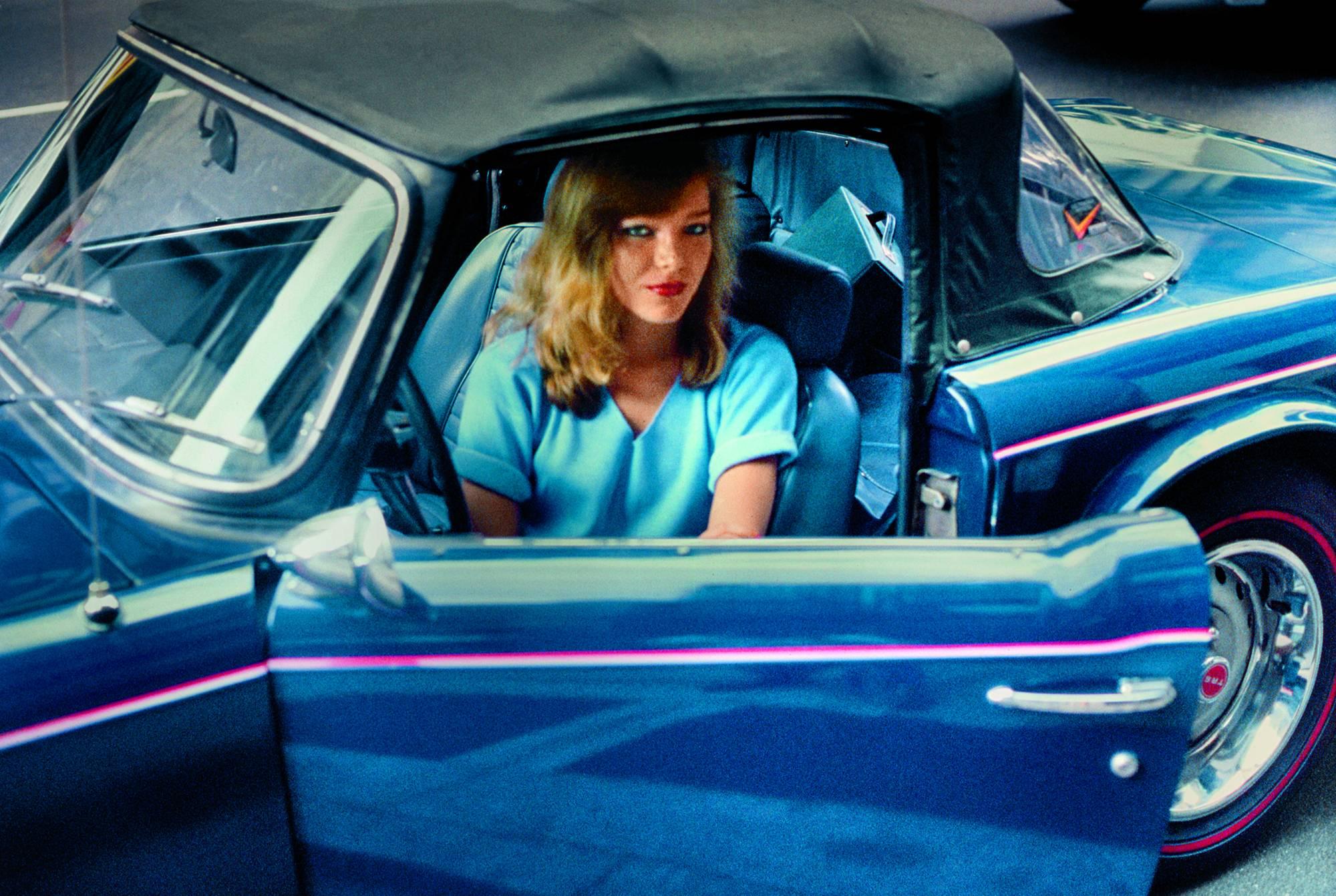 Robert Herman Color Photograph - Blonde in a Blue Convertible, New York, NY 1981