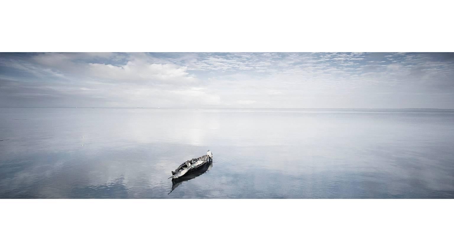 Chris Gordaneer Color Photograph - Man and Boat, Zanzibar