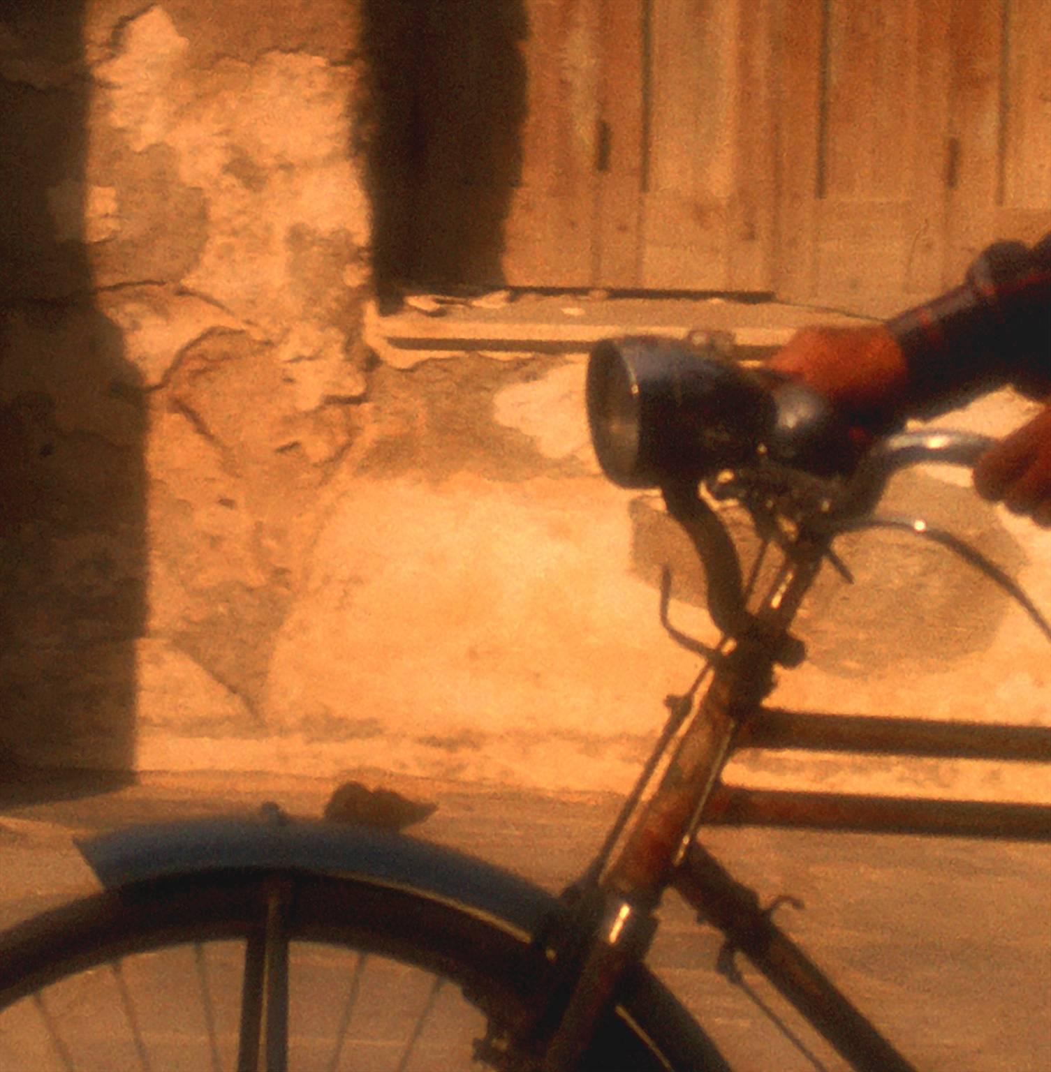 Man on Bike, Crete - Brown Color Photograph by George Simhoni