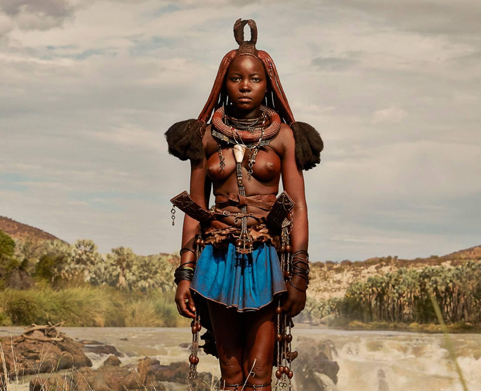 Himba Woman Epupa Falls 4 - Photograph by Chris Gordaneer