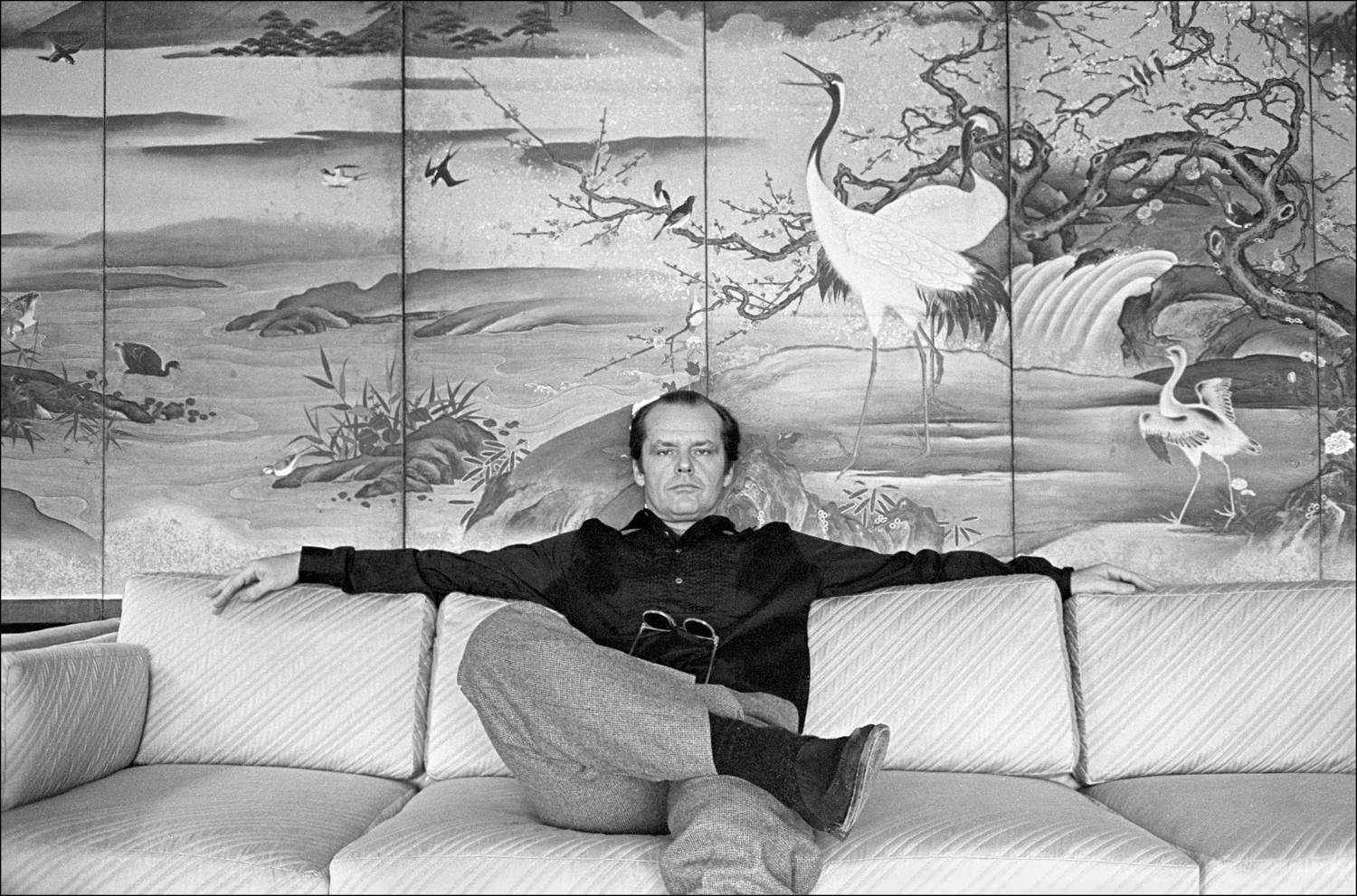 Allan Tannenbaum Black and White Photograph - Jack Nicholson on the sofa in his room at the Carlyle Hotel in 1981