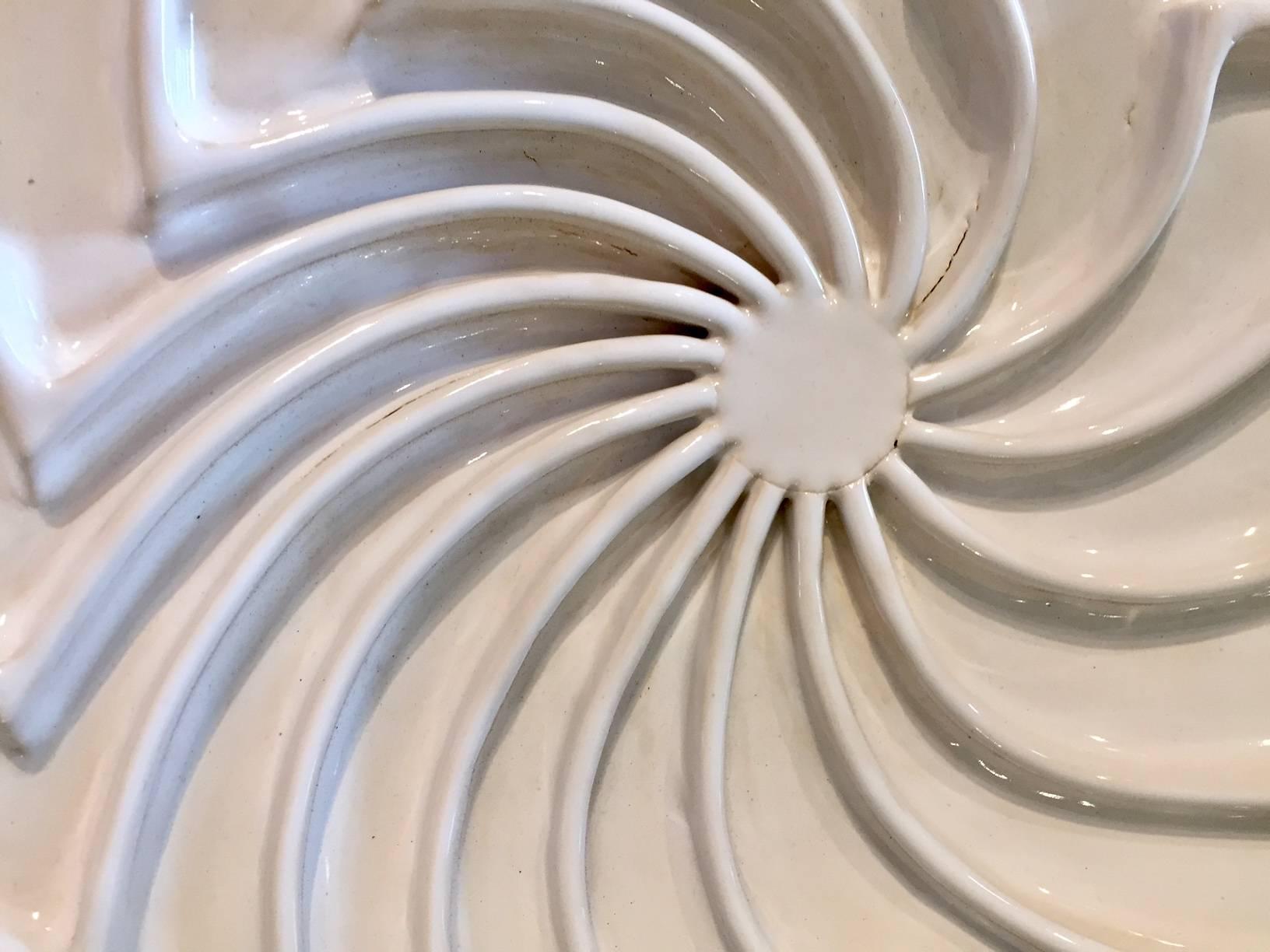 White circular abstract wall sculpture from Pop Art pioneer Jane B. Grimm, who began her artistic career in the 1960’s, when her free-form sculptural jewelry exploded onto the fashion scene in NYC. Her designs spoke to a new generation well into the