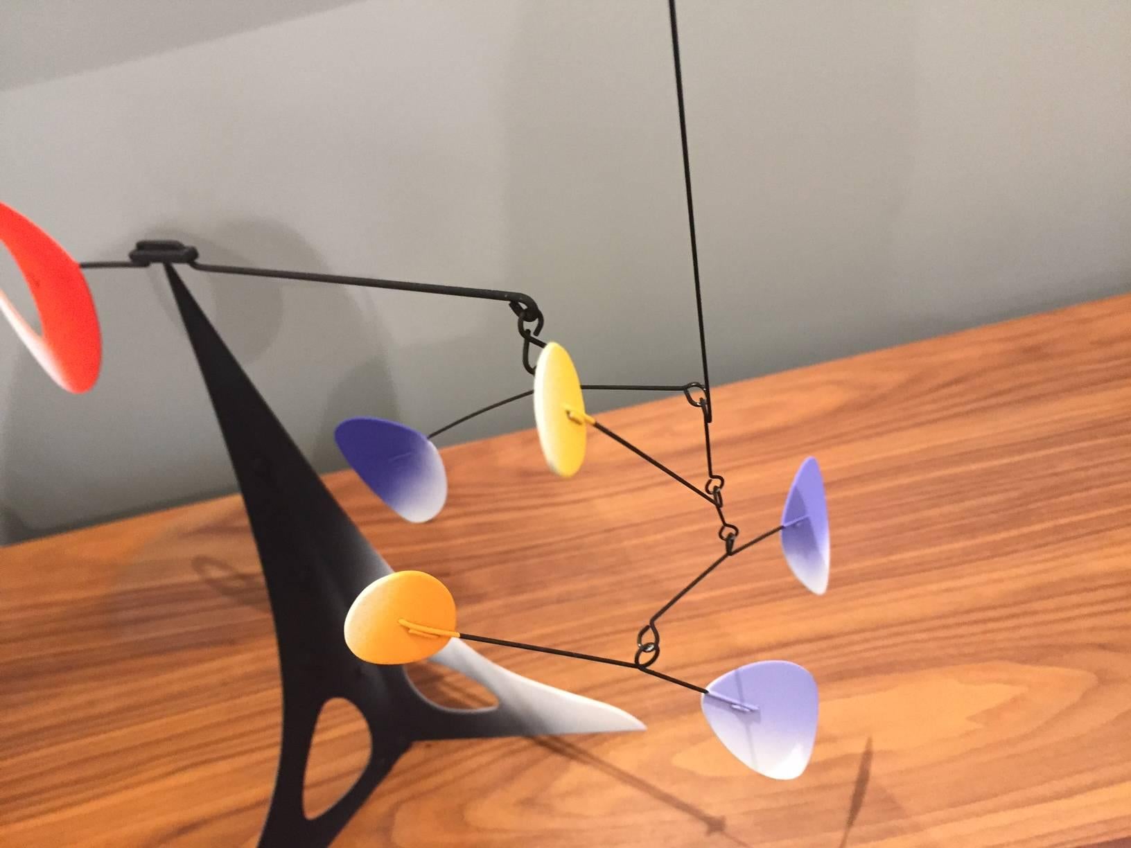 Indoor balancing stabile sculpture in black and white with red, blue and yellow, by contemporary sculptor Laurent Davidson, whose ariel sculptural mobiles and stabiles (balancing table sculptures) are inspired by nature and composed like music. A