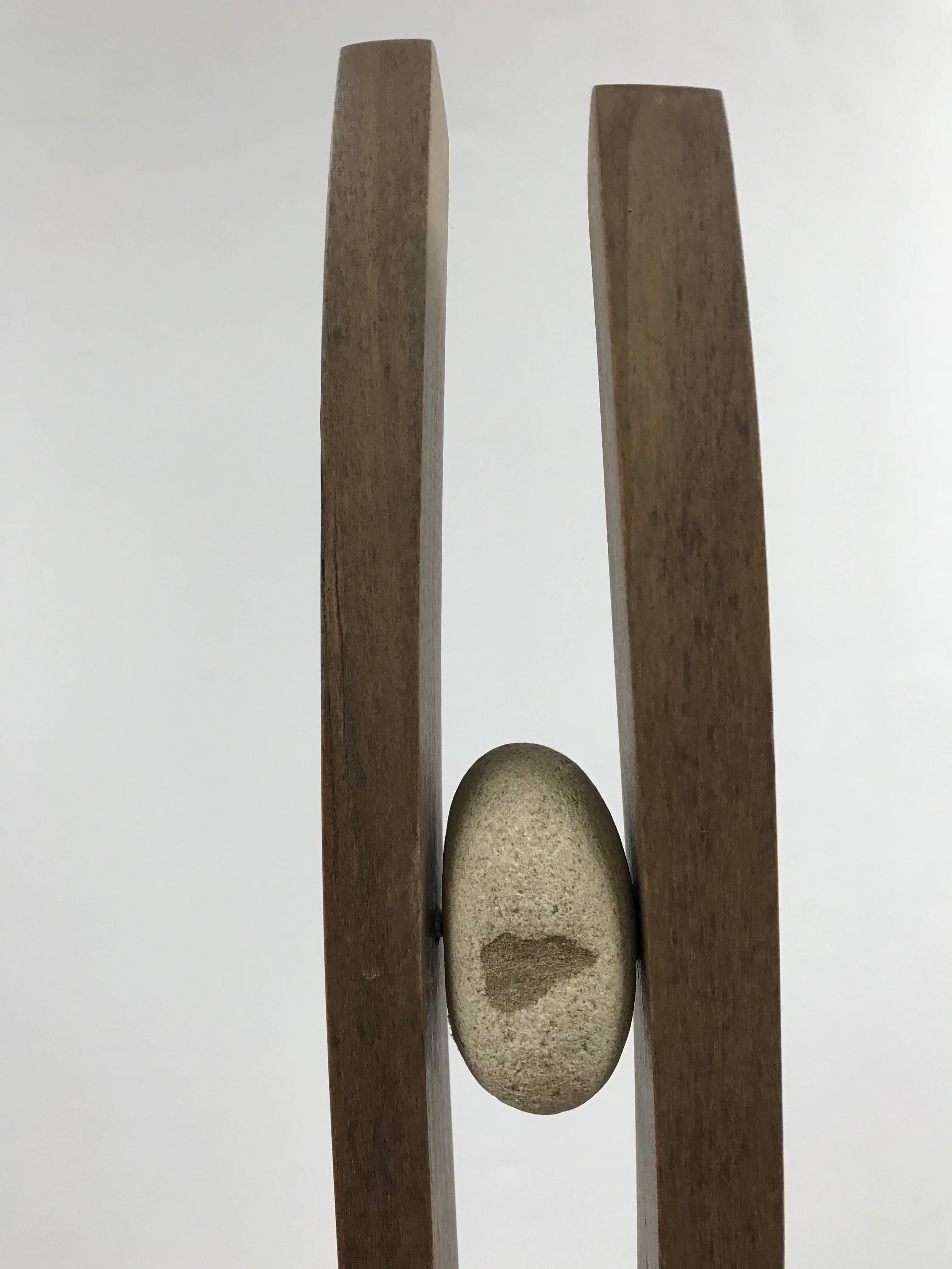 Gregory West, "Found Belonging", Wood and stone, 30in. x 6in. x 6in.

From the artist:
