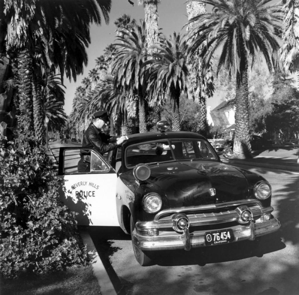 Slim Aarons Black and White Photograph - 'Beverly Hills Cop' California (Estate Stamped Edition)