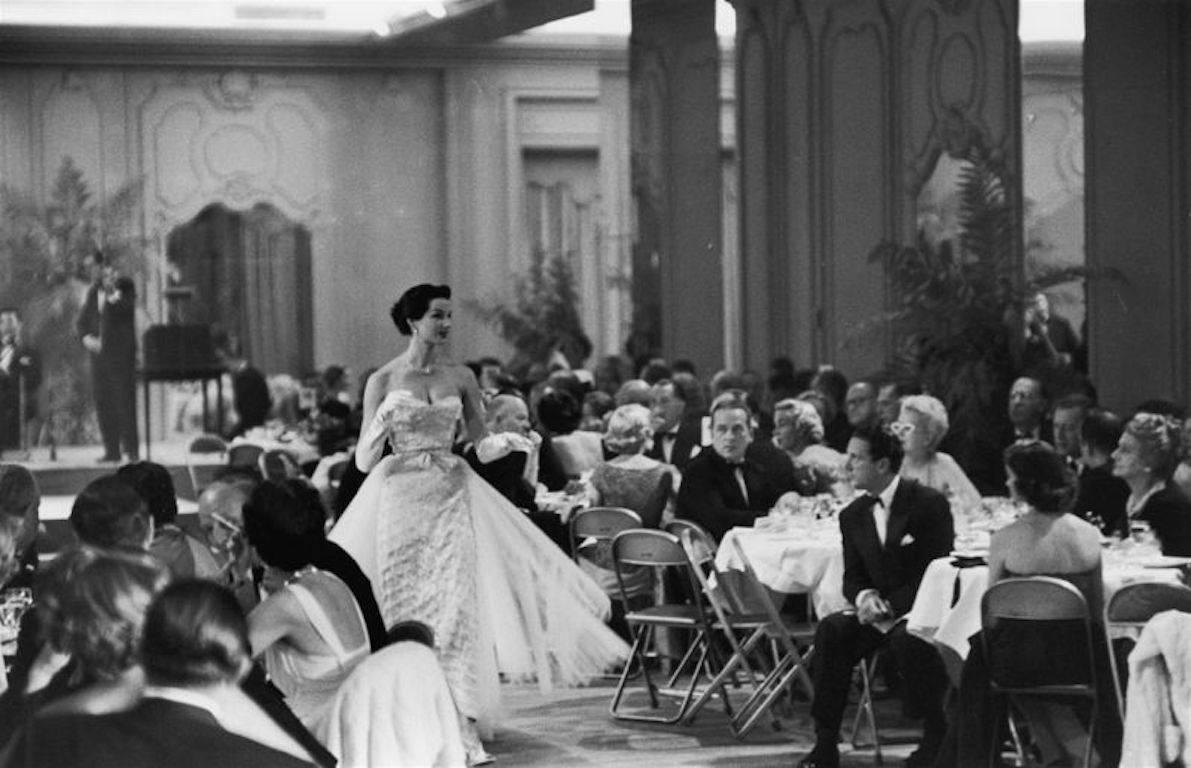 Slim Aarons Black and White Photograph - 'Saks Fashion Show' (Estate Stamped Edition)