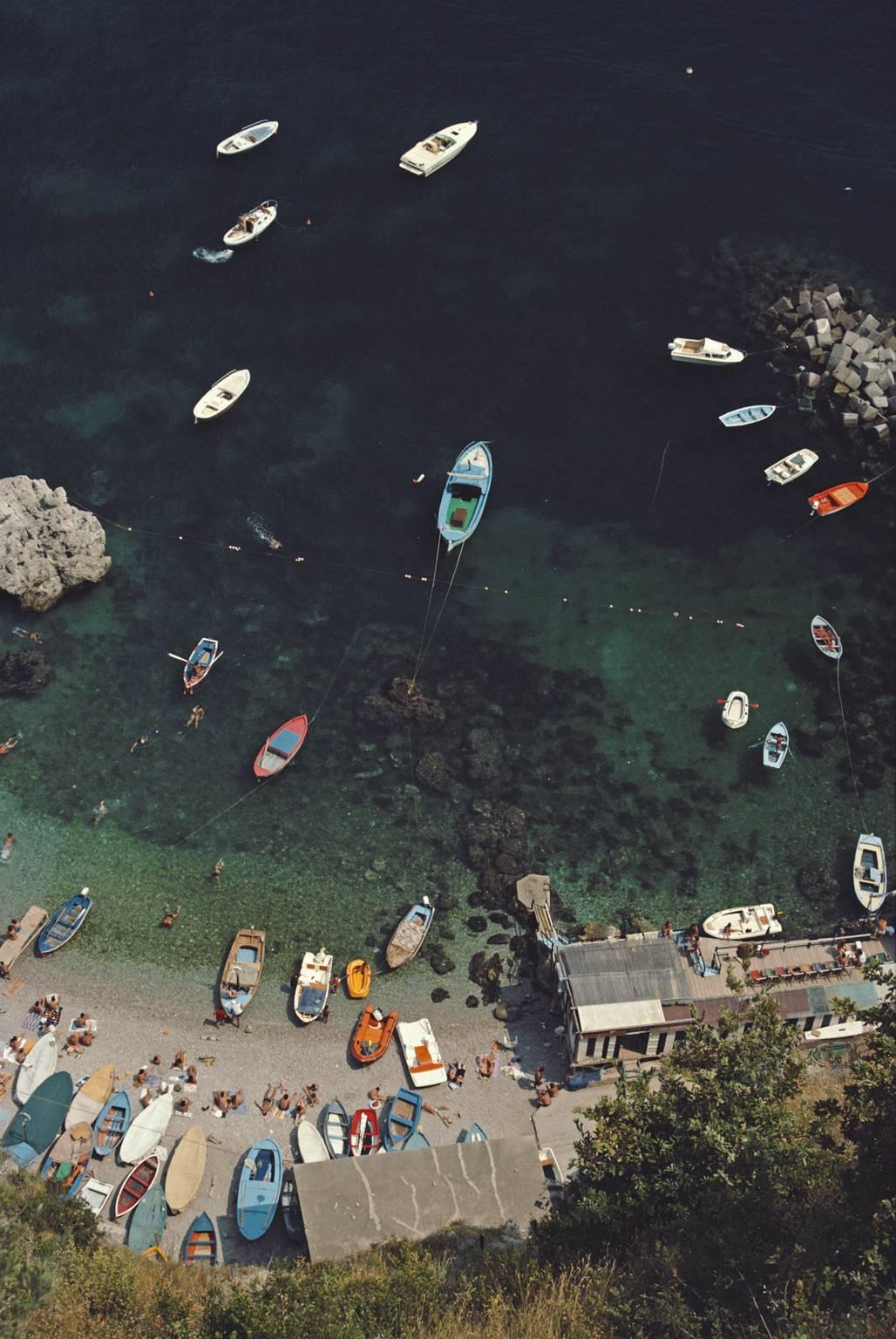 'Conca Dei Marini' by Slim Aarons

A busy bay in Conca dei Marini, on the Amalfi coast in Italy, August 1984.

A fabulous aerial shot looking down on the Conca dei Marini on the Italian coast, colourful boats are dotted along the shoreline and in