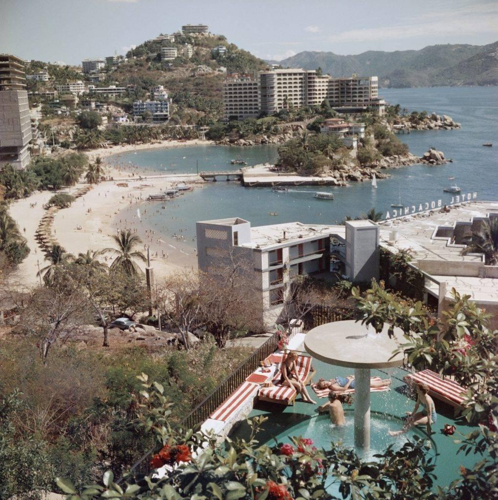 Slim Aarons Color Photograph - 'Caleta Beach, Acapulco' (Estate Stamped Edition)