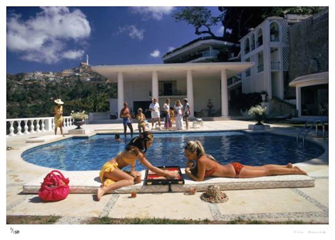 'Poolside Backgammon' Acapulco (Estate Stamped Edition) - Photograph by Slim Aarons