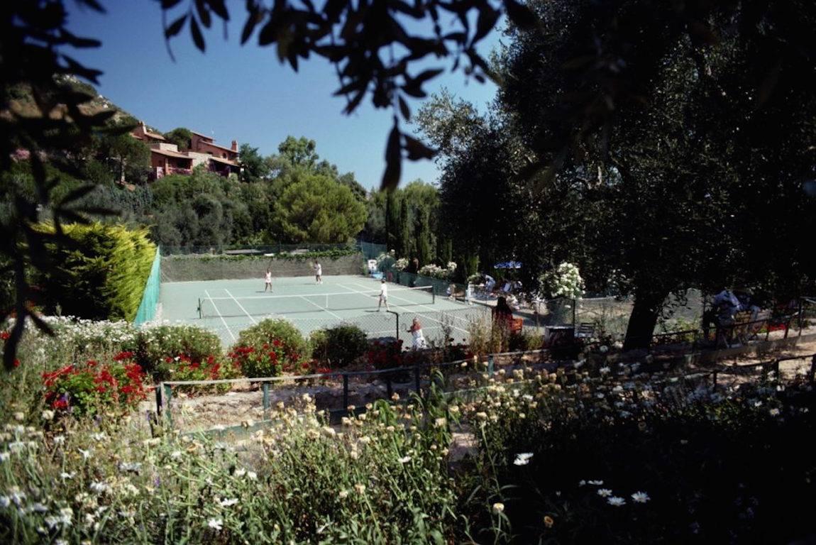 Slim Aarons Color Photograph - 'Il Pellicano Tennis' Porto Ercole (Estate Stamped Edition)