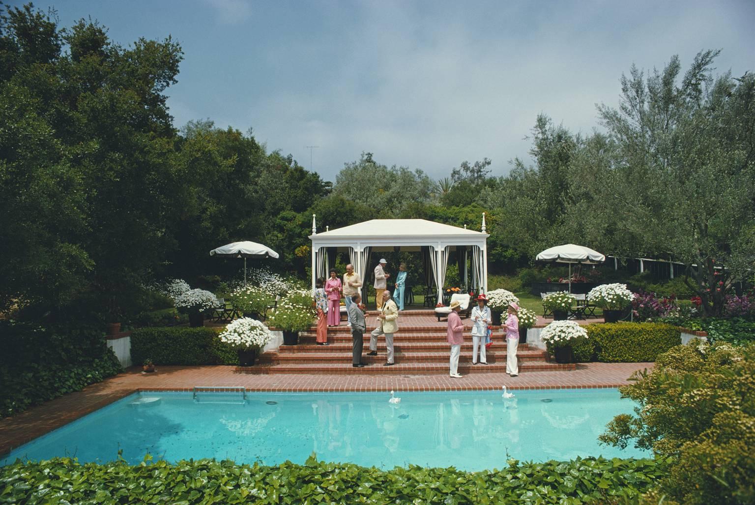 Fashionable guests attend a poolside luncheon at the home of Dorothy Laughlin in Santa Barbara, California, May 1975.

Typically 'Slim' this photograph epitomises the travel style and glamour of the period's wealthy and famous, beautifully
