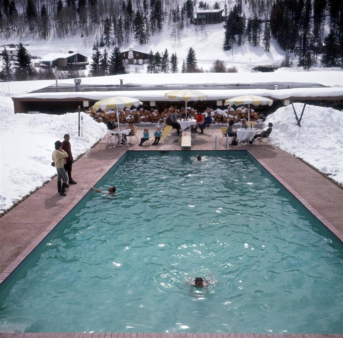 'Snow Round The Pool' by Slim Aarons

Bathers having a winter dip in a pool at Vail, Colorado, March 1964.

A gorgeous scene; a couple of bathers enjoy a dip, the turquoise waters of the swimming pool surround them and glisten in the winter sun, in