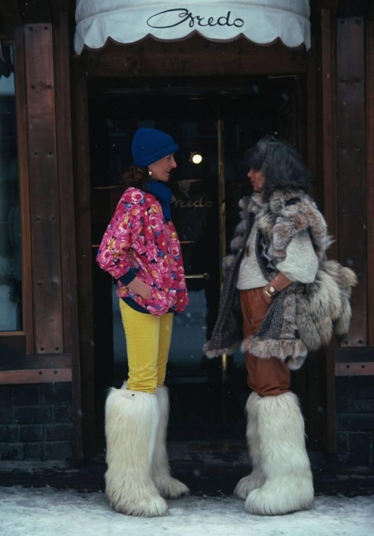 'Cortina d’Ampezzo' (Slim Aarons Estate Edition)

Isa Genolini and Maria Antonia in the main street of Cortina d’Ampezzo, Italy, March 1982.

Two stylishly dressed ladies are seen chatting in the street of Cortina D'Ampezzo. They are both wearing