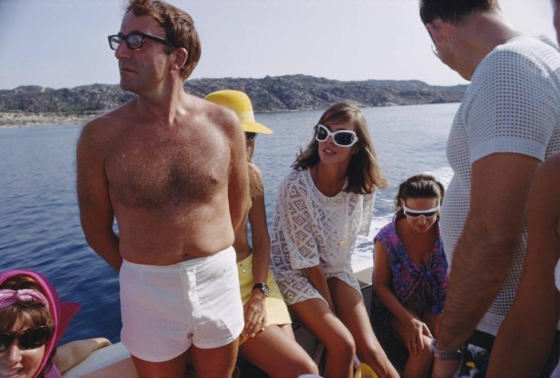 'Celebrity Cruise'  (Slim Aarons Estate Edition)

British comedian Peter Sellers (1925 - 1980) holidays with Princess Margaret (1930 - 2002, right) on the Aga Khan's yacht on the Costa Smeralda, circa 1955.

This photograph epitomises the travel
